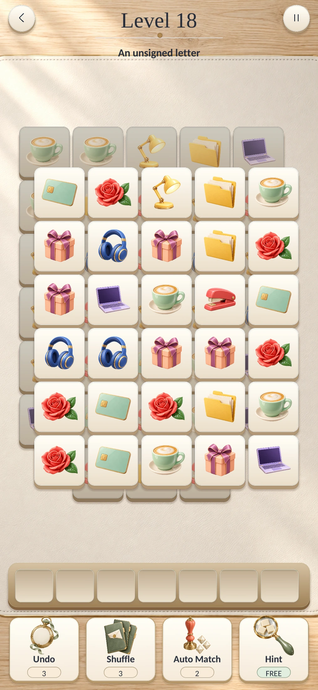 Actual game screen: layered office-themed tiles, a seven-slot tray and four boosters